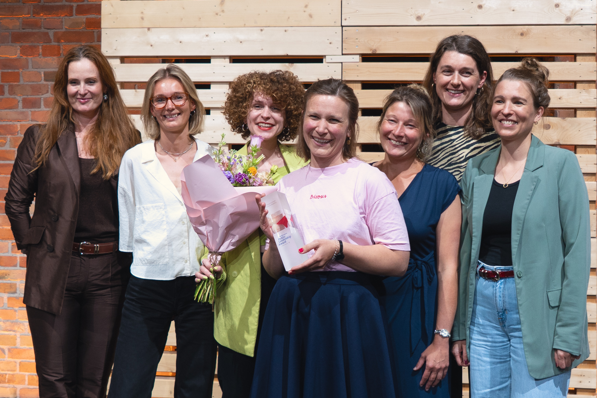 Das Fellowship-Team von Work4Germany posiert lächeln mit dem Preis „Public Leadership Award 2025“ für die Kamera.